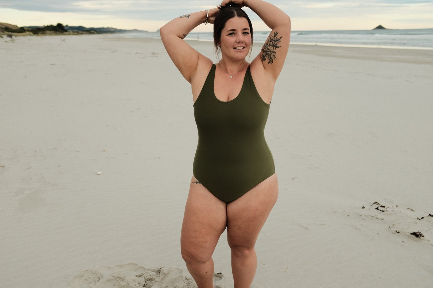 woman wearing juno onepiece in olive colour at beach