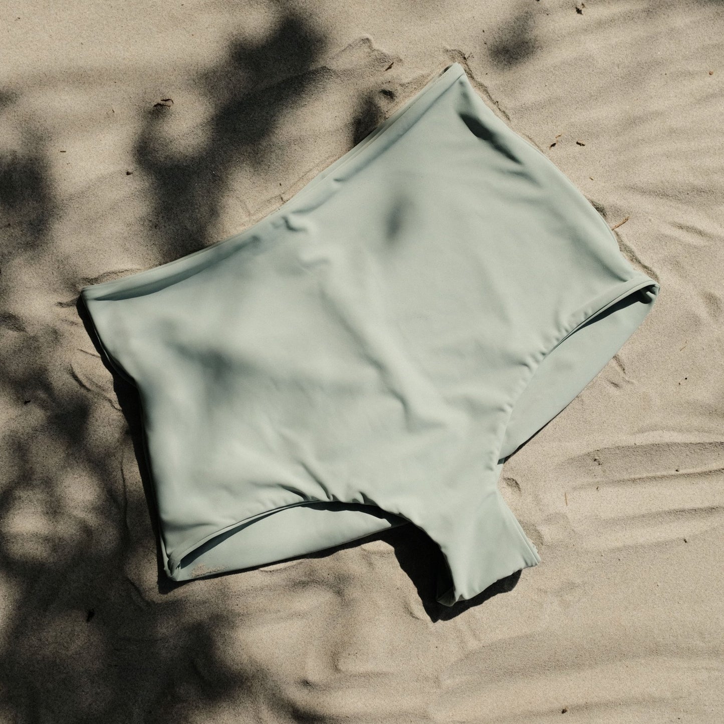 Pearl swim bottoms in Mist colour on sand