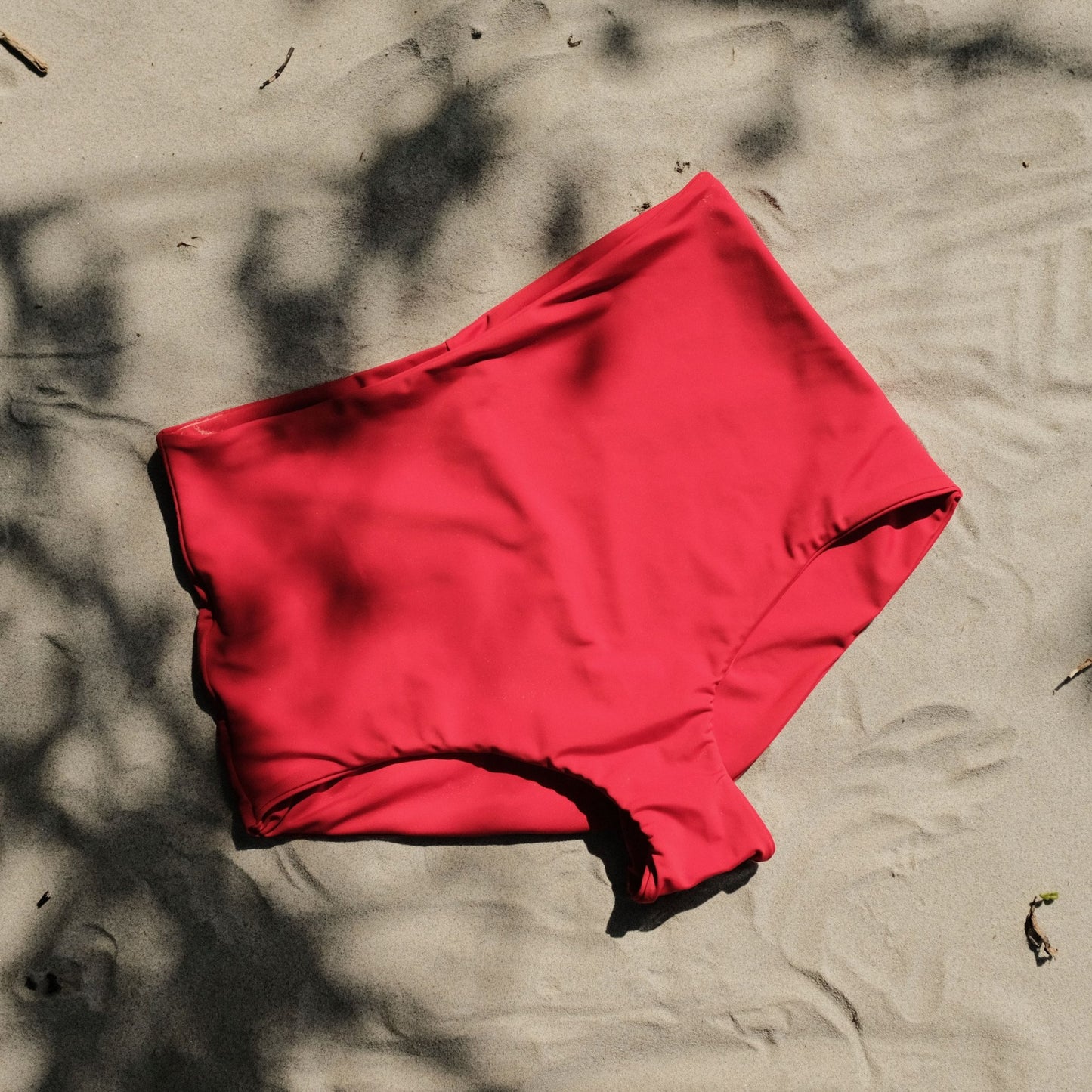Pearl swim bottoms in Siren colour on sand