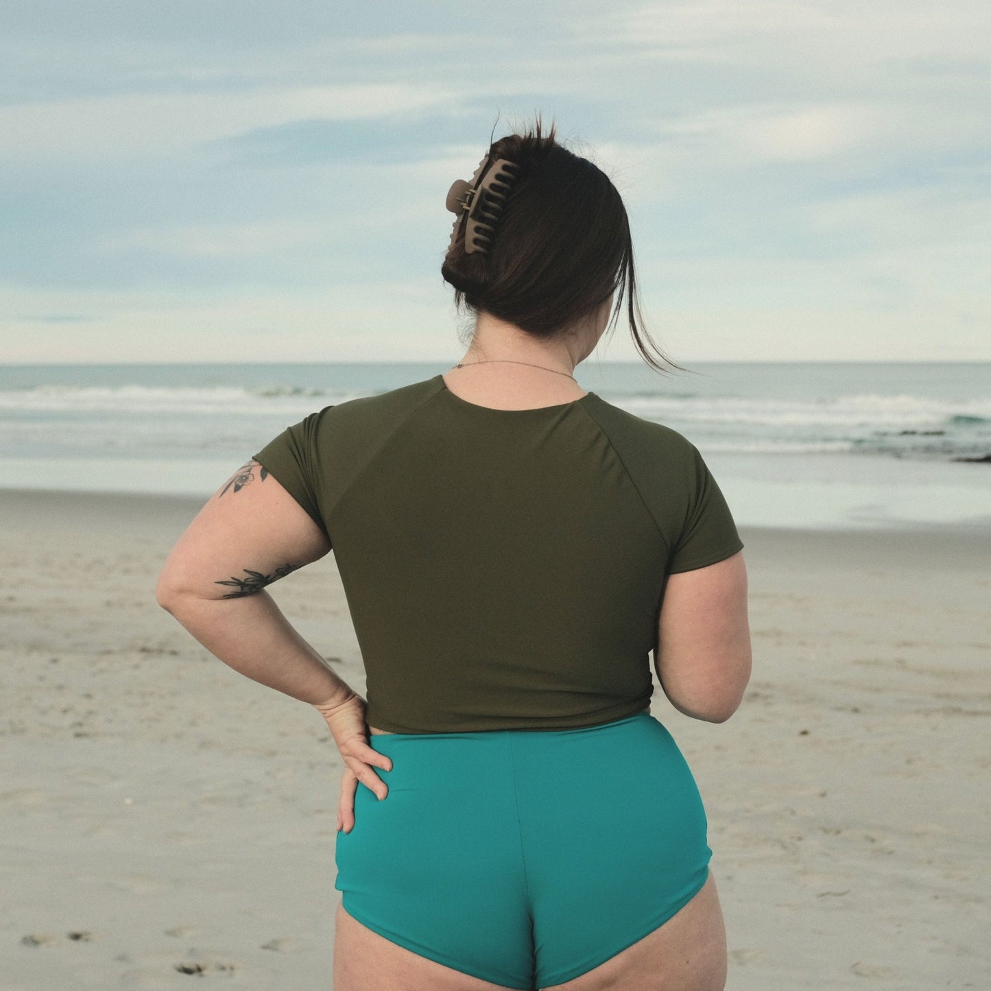 Woman wearing ray rashie short sleeve variation on beach