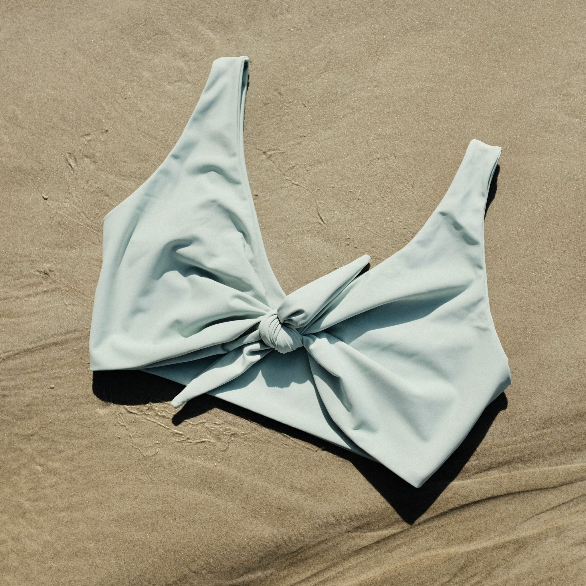 Lenny swim top in Mist colour on sand