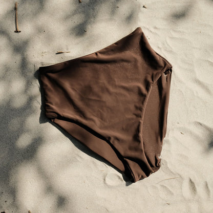 Peach swim bottoms in Espresso colour on sand