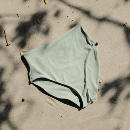 Peach swim bottoms in Mist on sand