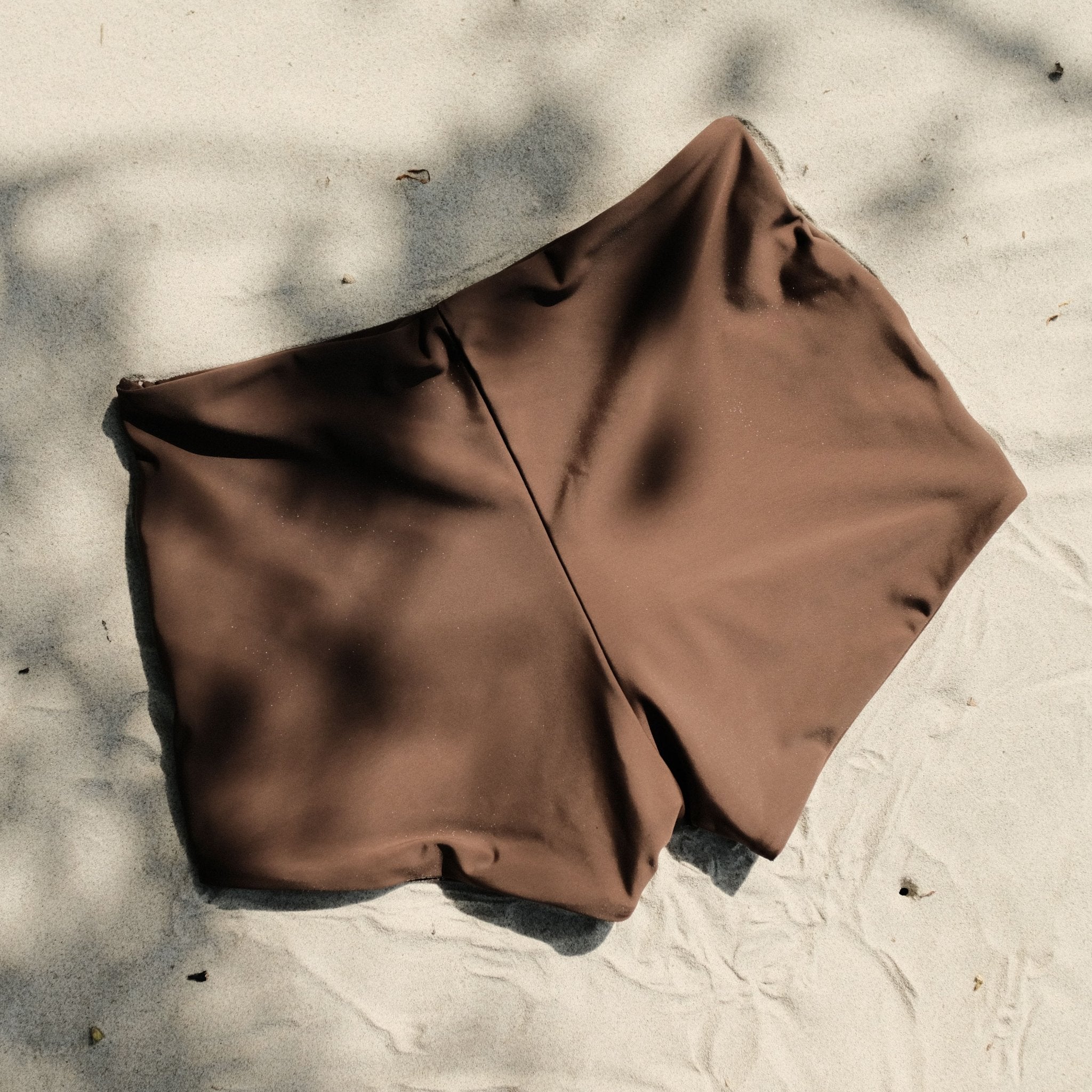 Pearl swim bottoms in Espresso on sand