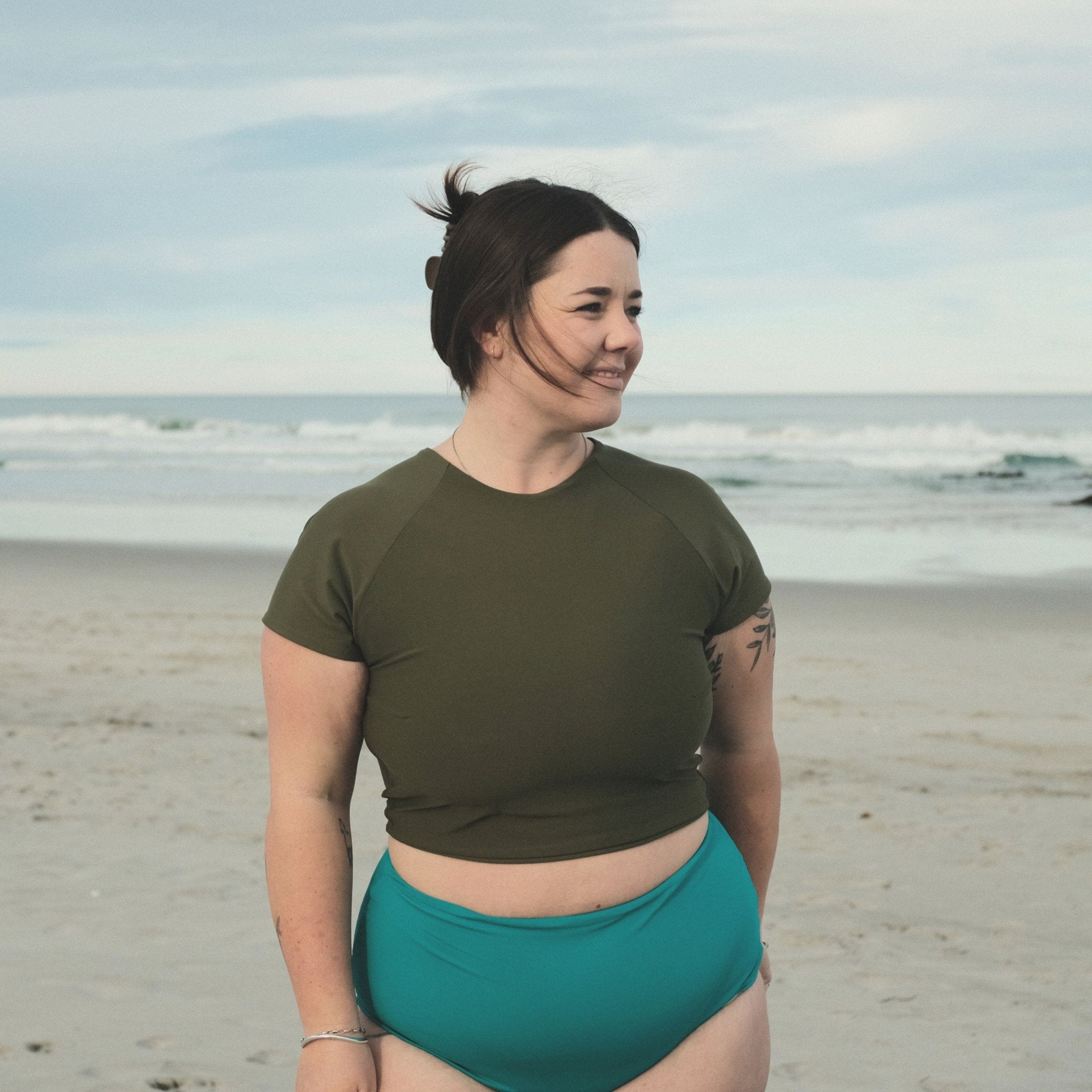 Woman wearing ray rashie short sleeve variation on beach